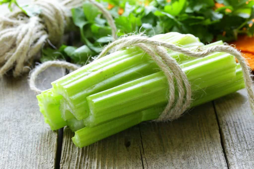 stalks of celery on wooden table