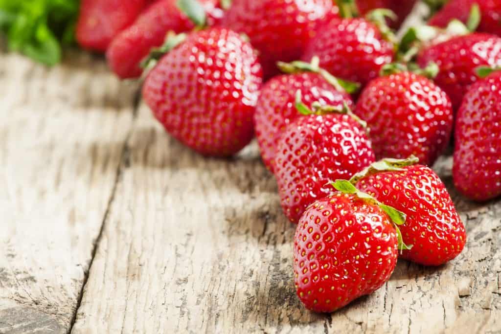 Fresh ripe strawberries on a wooden table