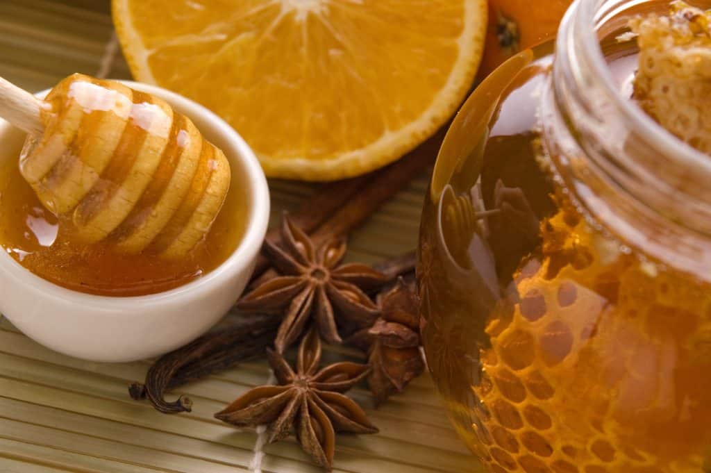 Fresh honey with honeycomb, lemons, oranges, cinnamon, vanilla, anise star