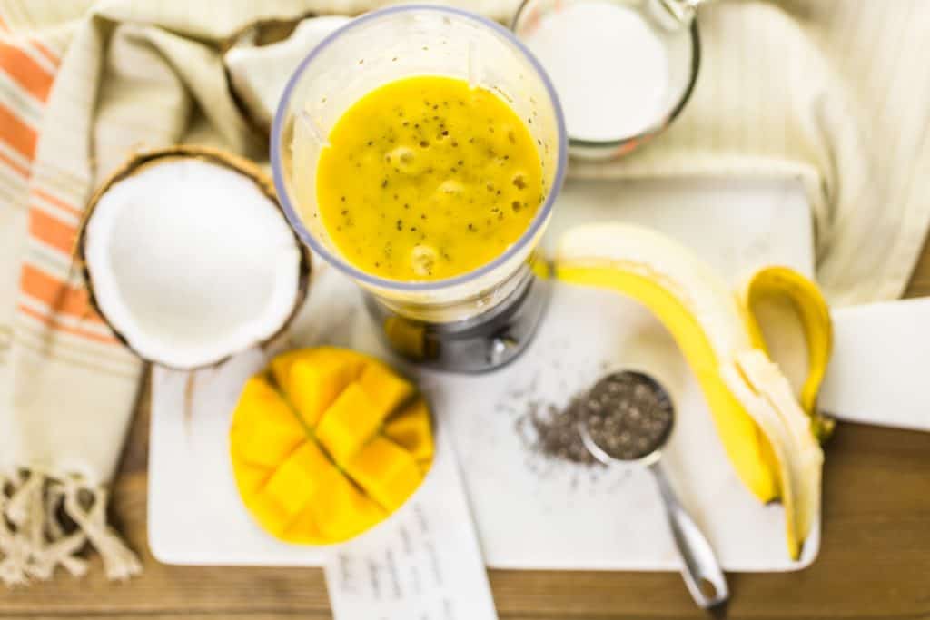 Freshly made mango banana smoothie with chia seeds.