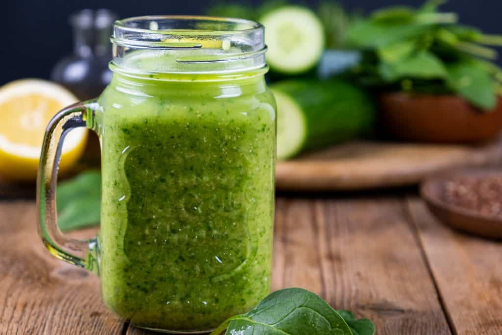 oatmeal and spinach smoothie on wooden background