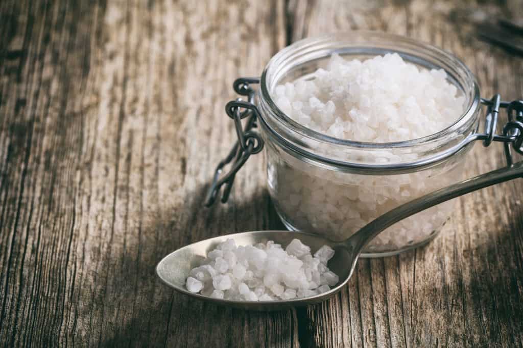 White salt crystals on a wooden surface