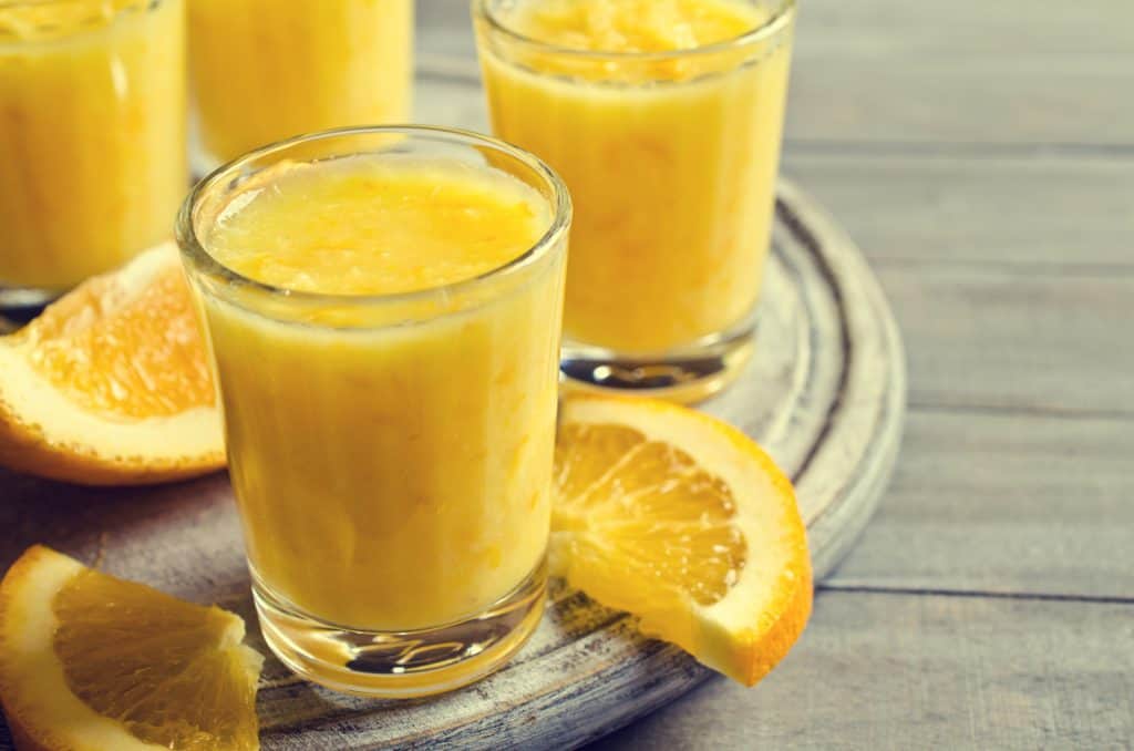 lemon smoothies with lemon slices in background