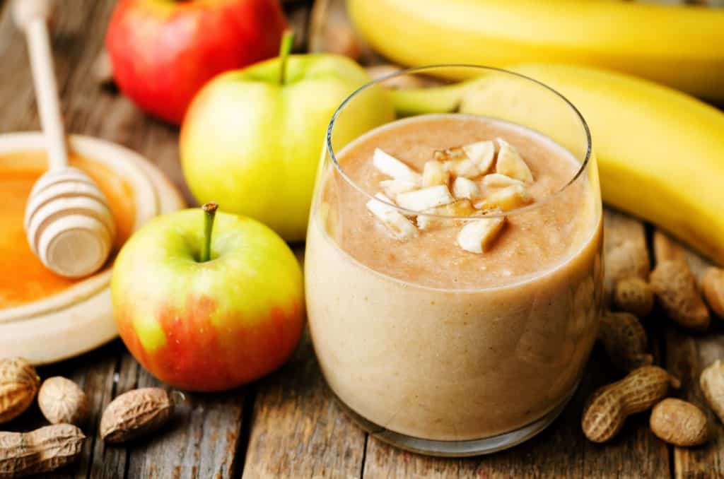 apple pie pre workout smoothie in glass on wooden background