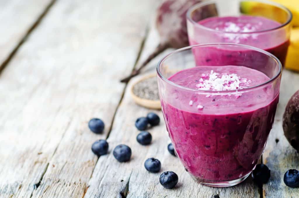 beet smoothie for weight loss in glasses on wooden background