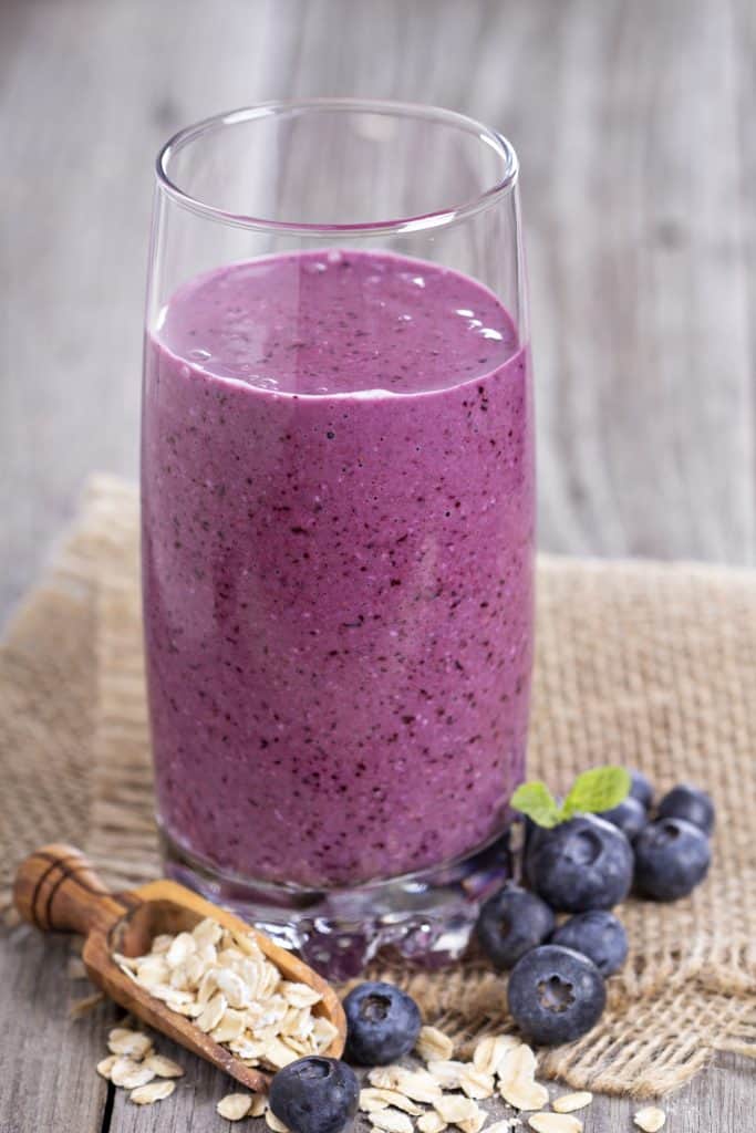 Smoothie with blueberries, banana and oatmilk in a glass