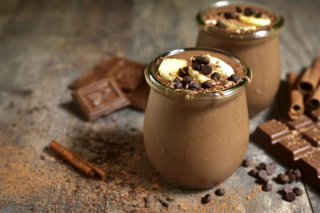 chocolate weight loss smoothies in jars with ingredients around