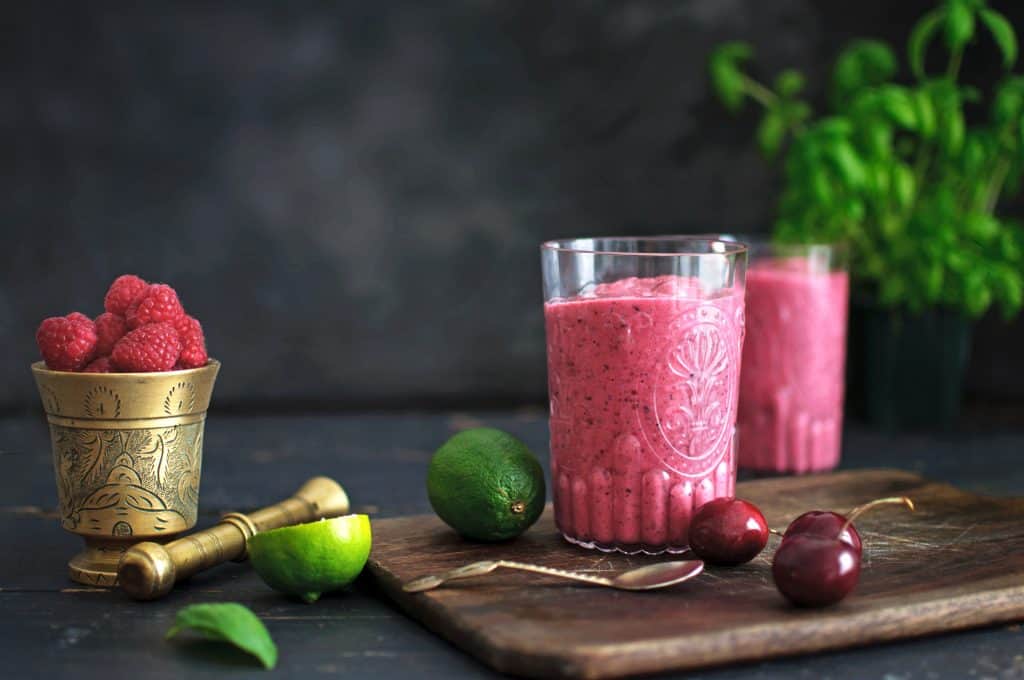 Frozen fruit smoothies without yogurt in glasses on wooden board