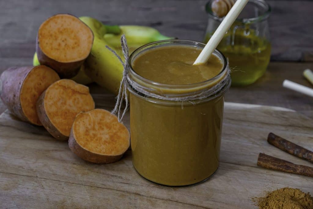 sweet potato smoothie for weight loss in jar with ingredients surrounding