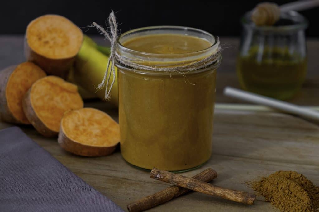 sweet potato weight loss smoothie on dark background with ingredients surrounding