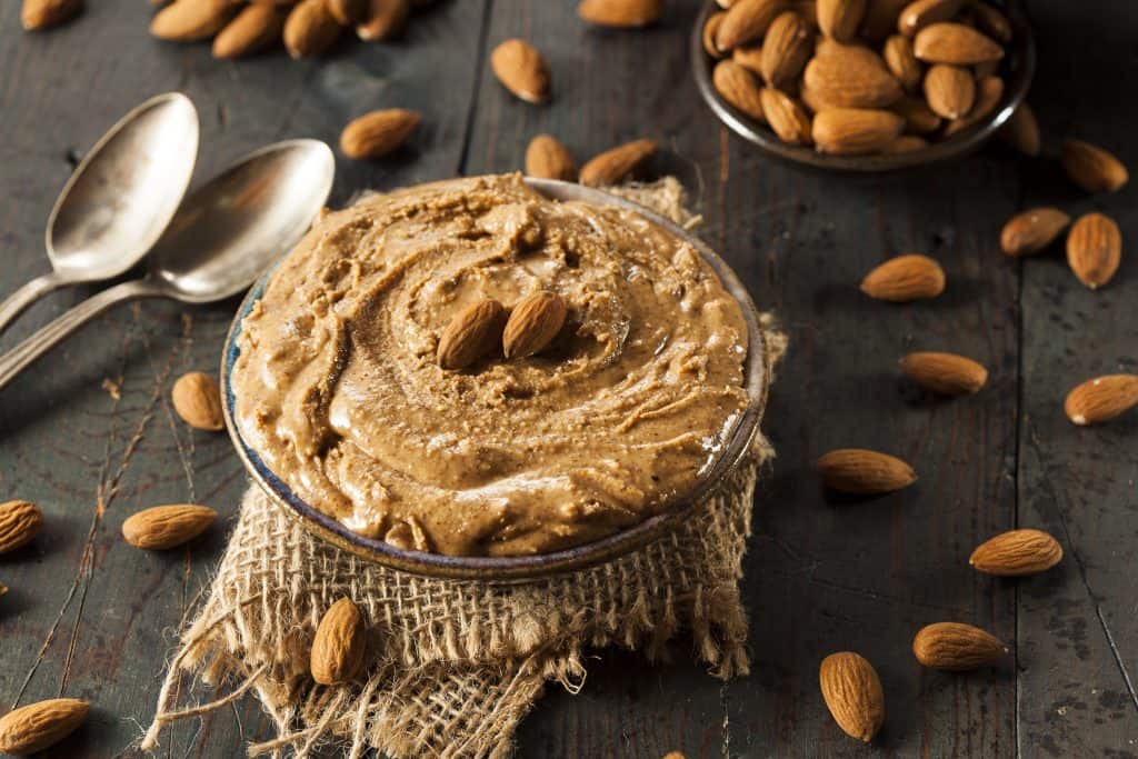 Raw Organic Almond Butter on a Wooden Background