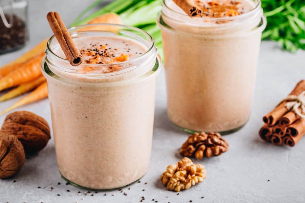 ginger smoothie in glasses with ingredients surrounding