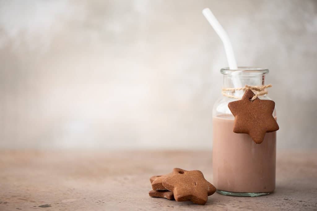 christmas smoothie in glass with gingerbread cookies