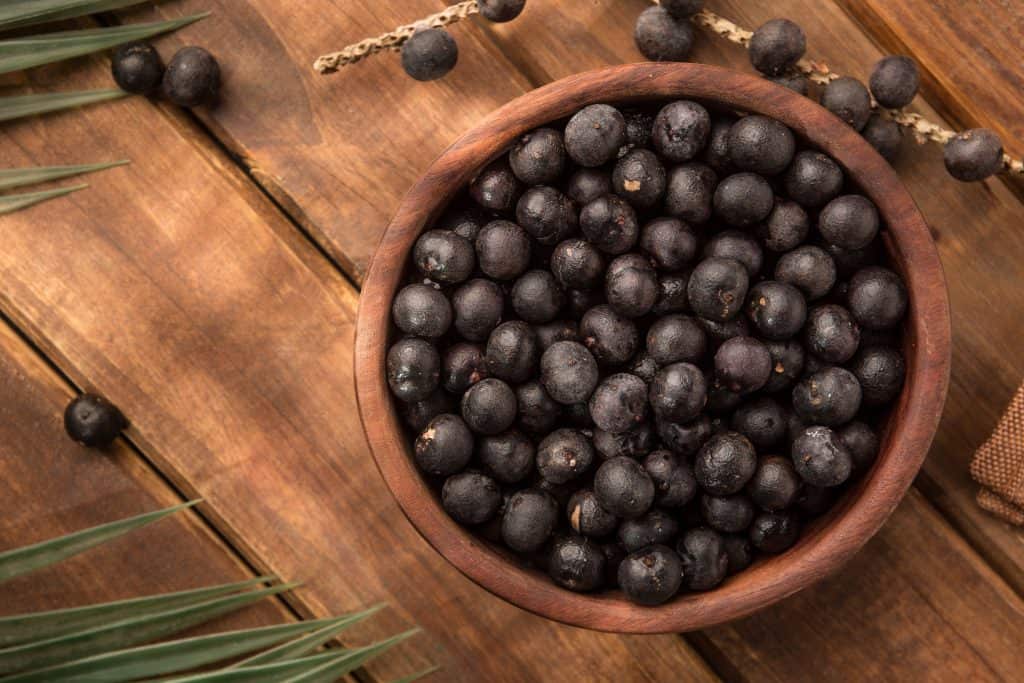 acai berries in wooden bowl