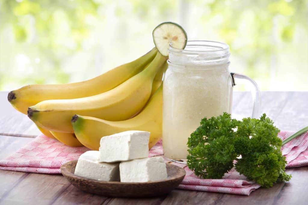 basic recipe for tofu smoothies for breakfast in glass with bananas and parsley