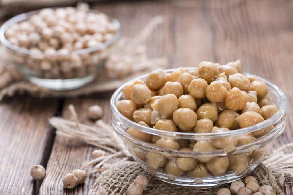 chickpeas in bowl on wooden table