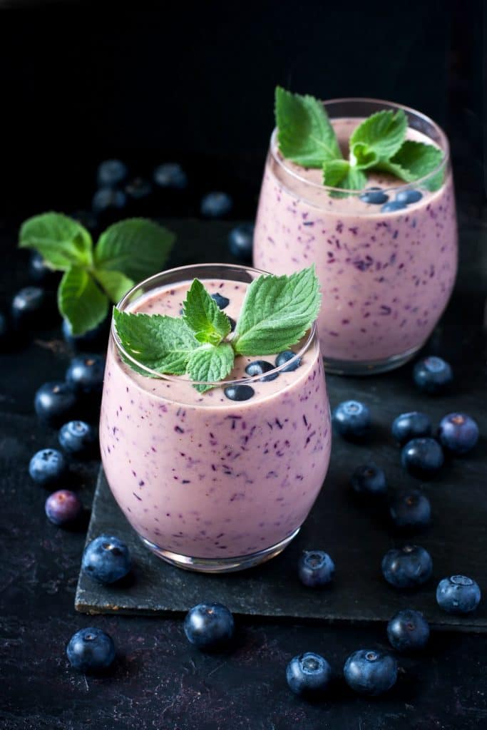 Delicious blueberry smoothie with mint and fresh berries in glasses,  selective focus