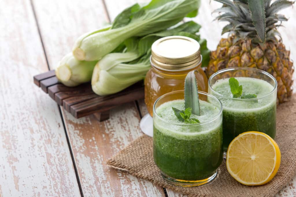 bok choy smoothies in glasses with ingredients behind