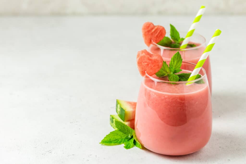 detox watermelon smoothies in glasses with straws, watermelon hearts and fresh mint leaves