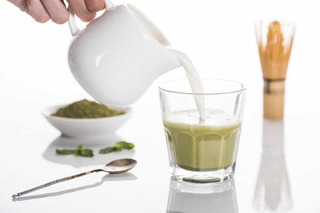 pouring milk into matcha tea