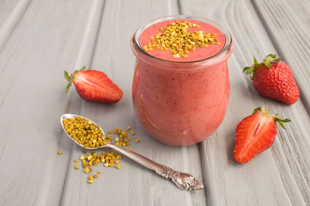 strawberry smoothie with bee pollen sprinkled on top