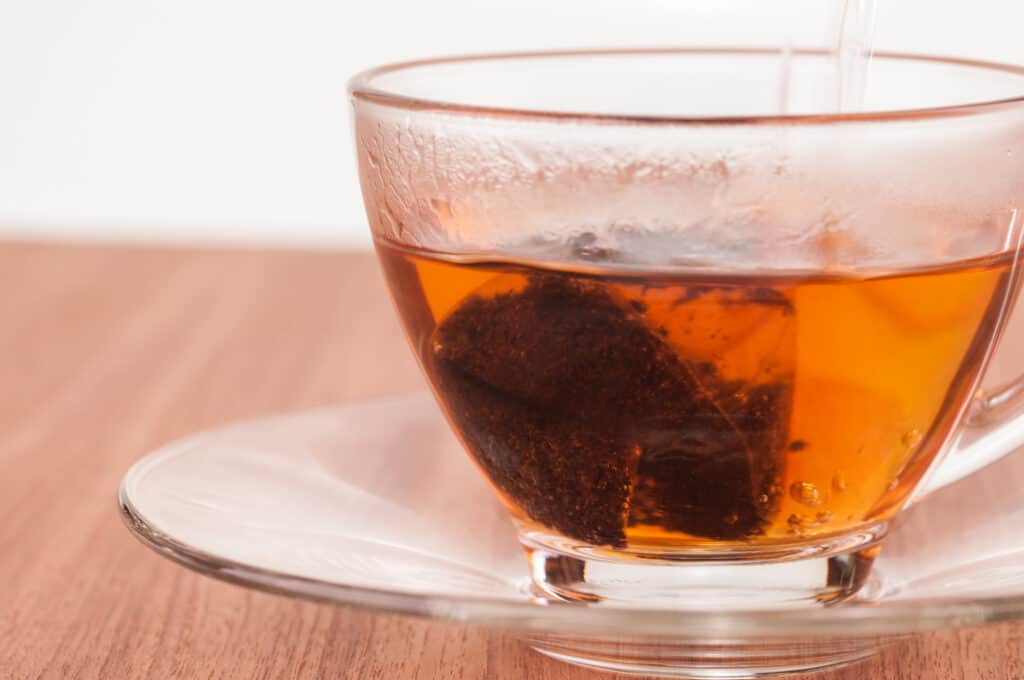 Hot tea in the making on a wooden table